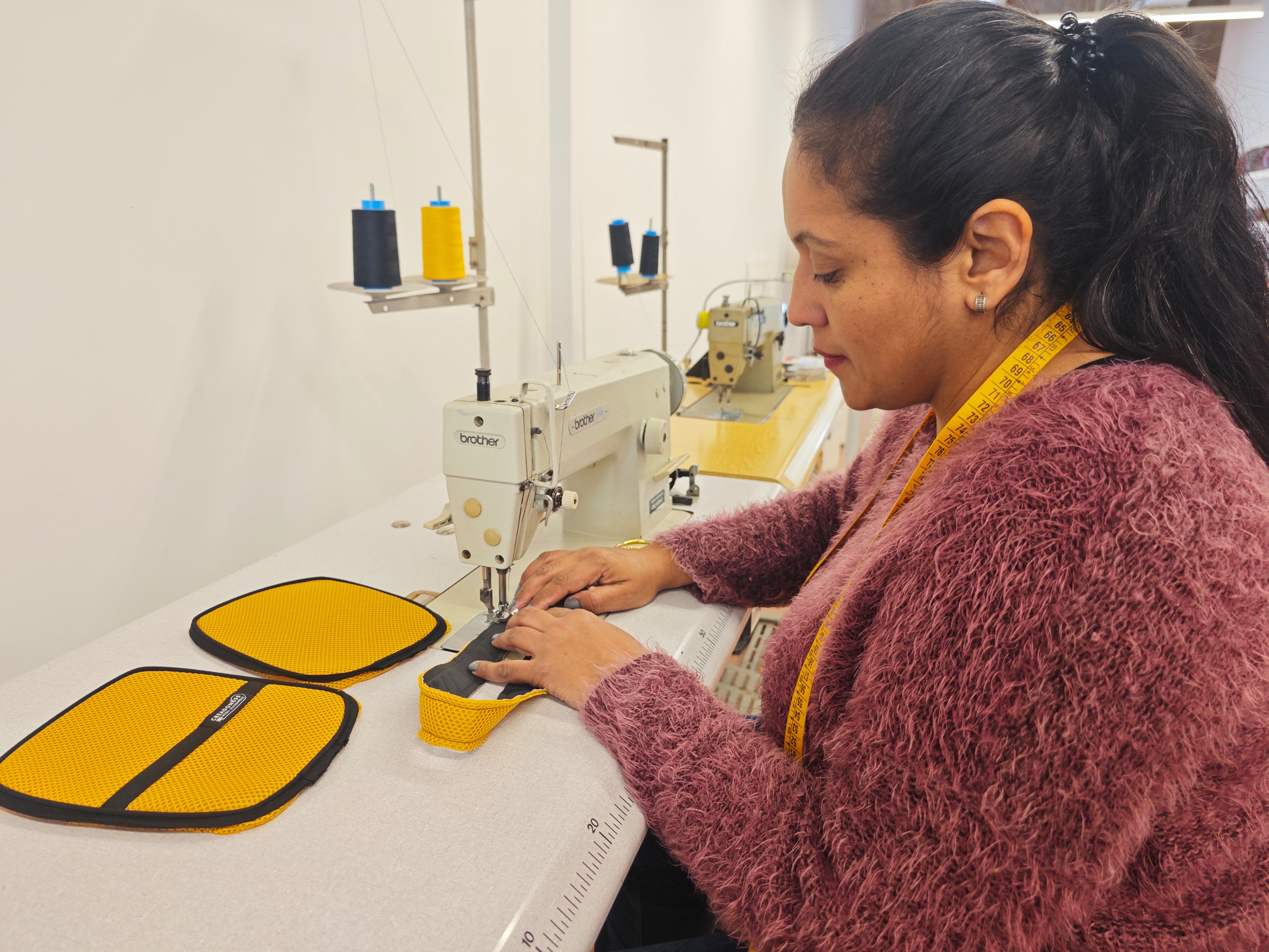 Mujer cosiendo la funda para kindle en el taller de Creadoness.