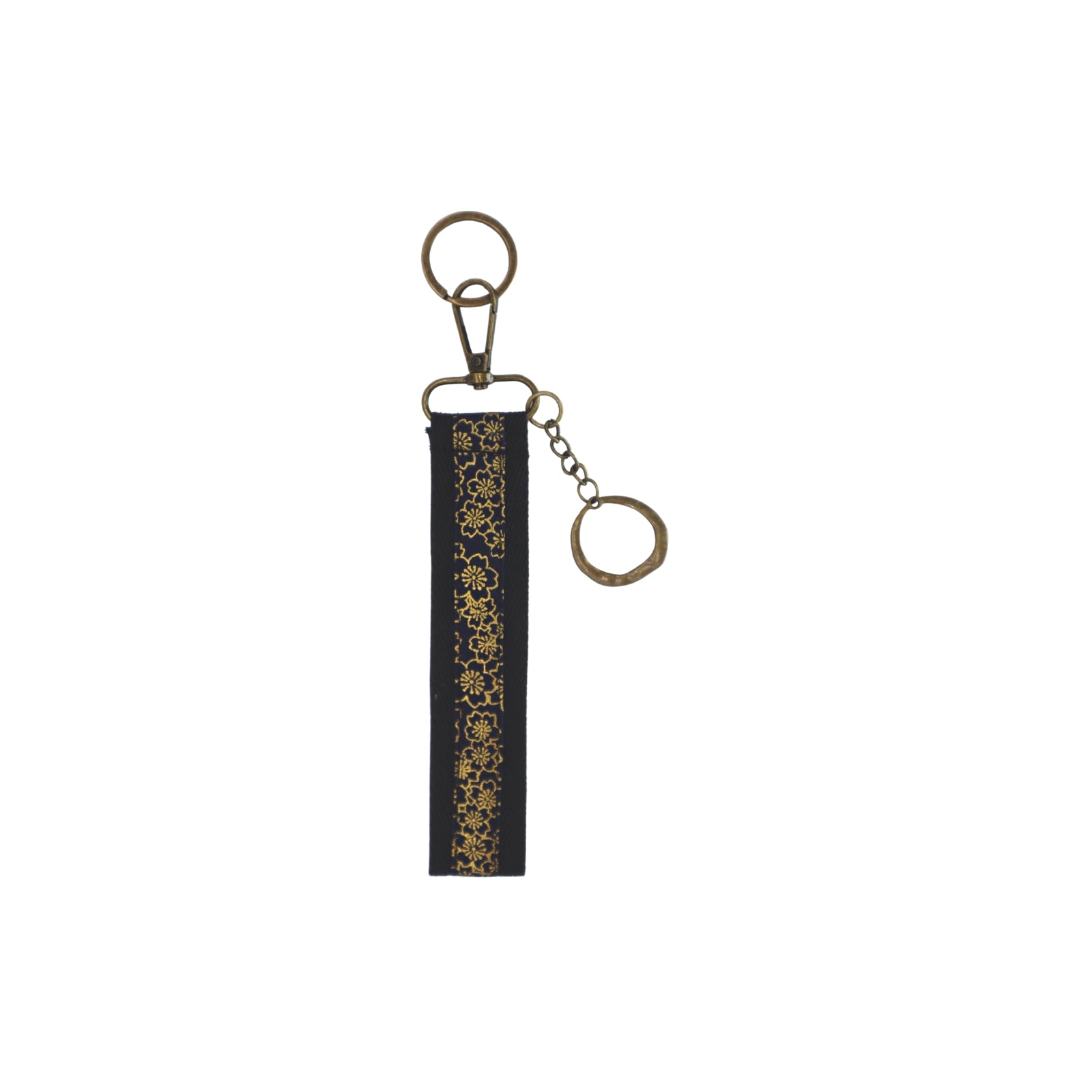 Llavero de algodón de color negro y detalles dorado. Su medida es de 14 cm y por su diseño permite colocarlo en la muñeca.